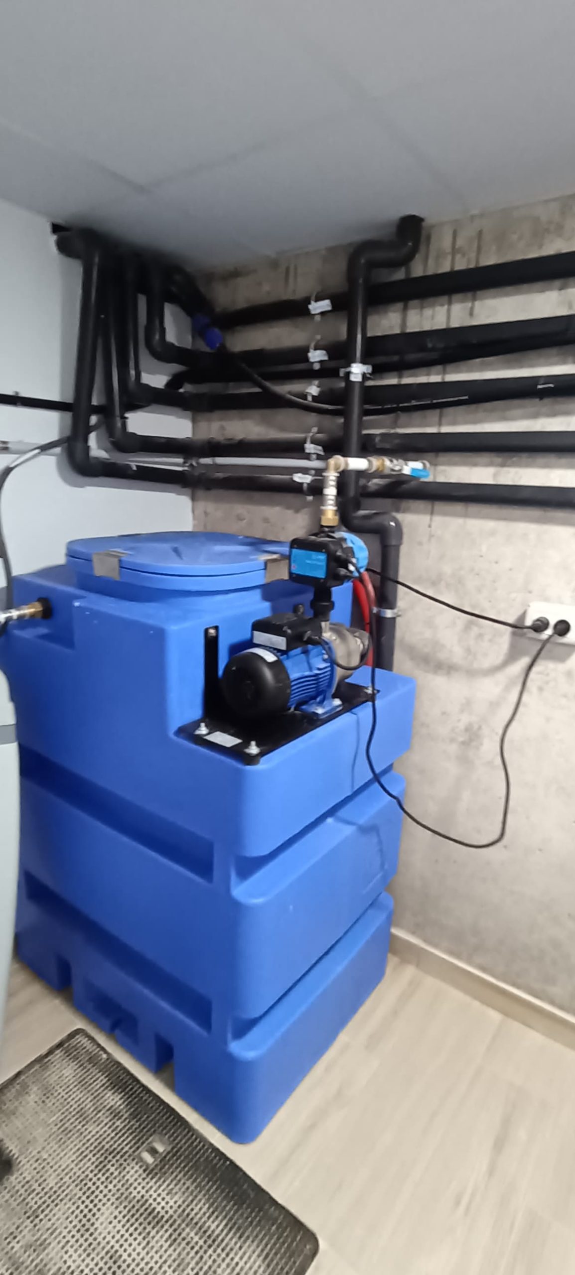 Técnico instalando sistema de fontanería o energía renovable en obra.